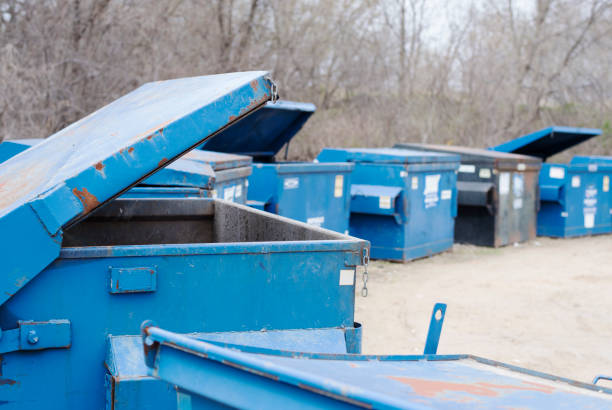Blue containers, some open ready for garbage, waste.